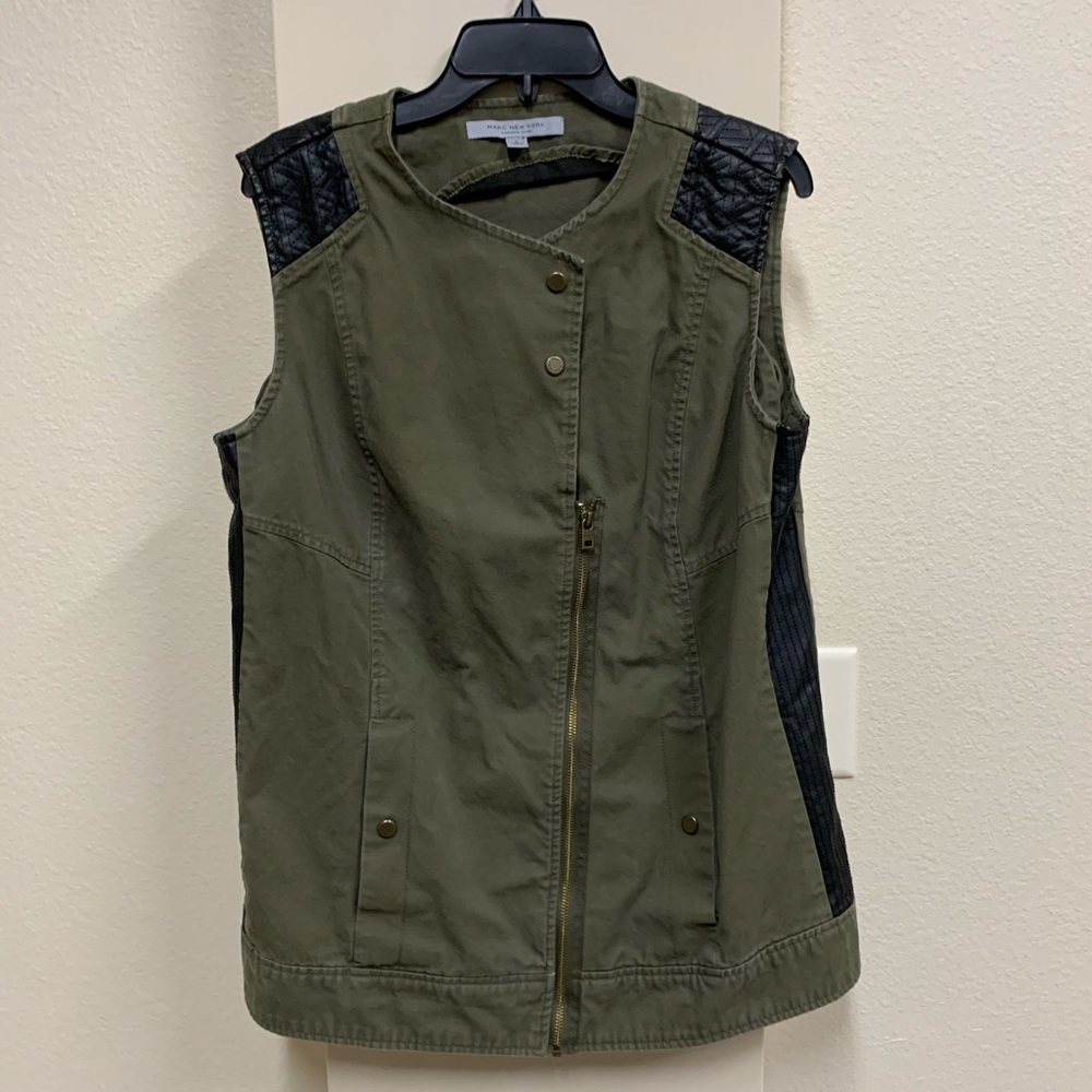 Army green vest with black faux leather details